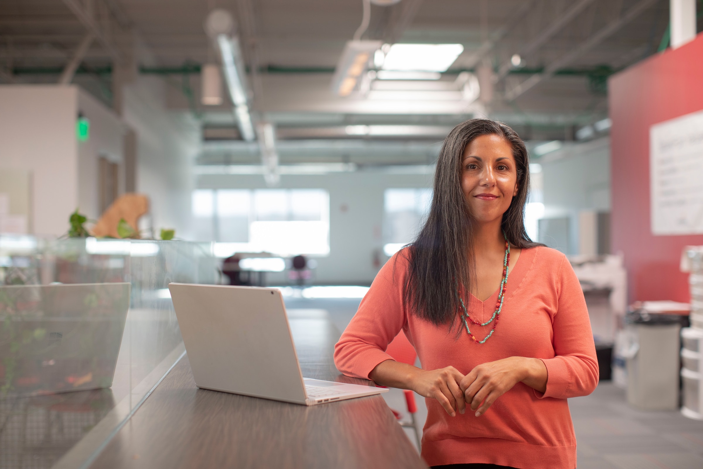 A woman presenting to colleagues in a bright office